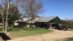 A house with a covered garage, a driveway, and a lawn.