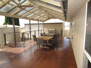 Enjoy dining al fresco on this patio with a table set and grill.