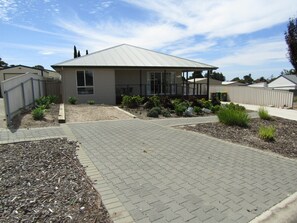 Stroll through the serene garden to the front porch of this charming single-story home.