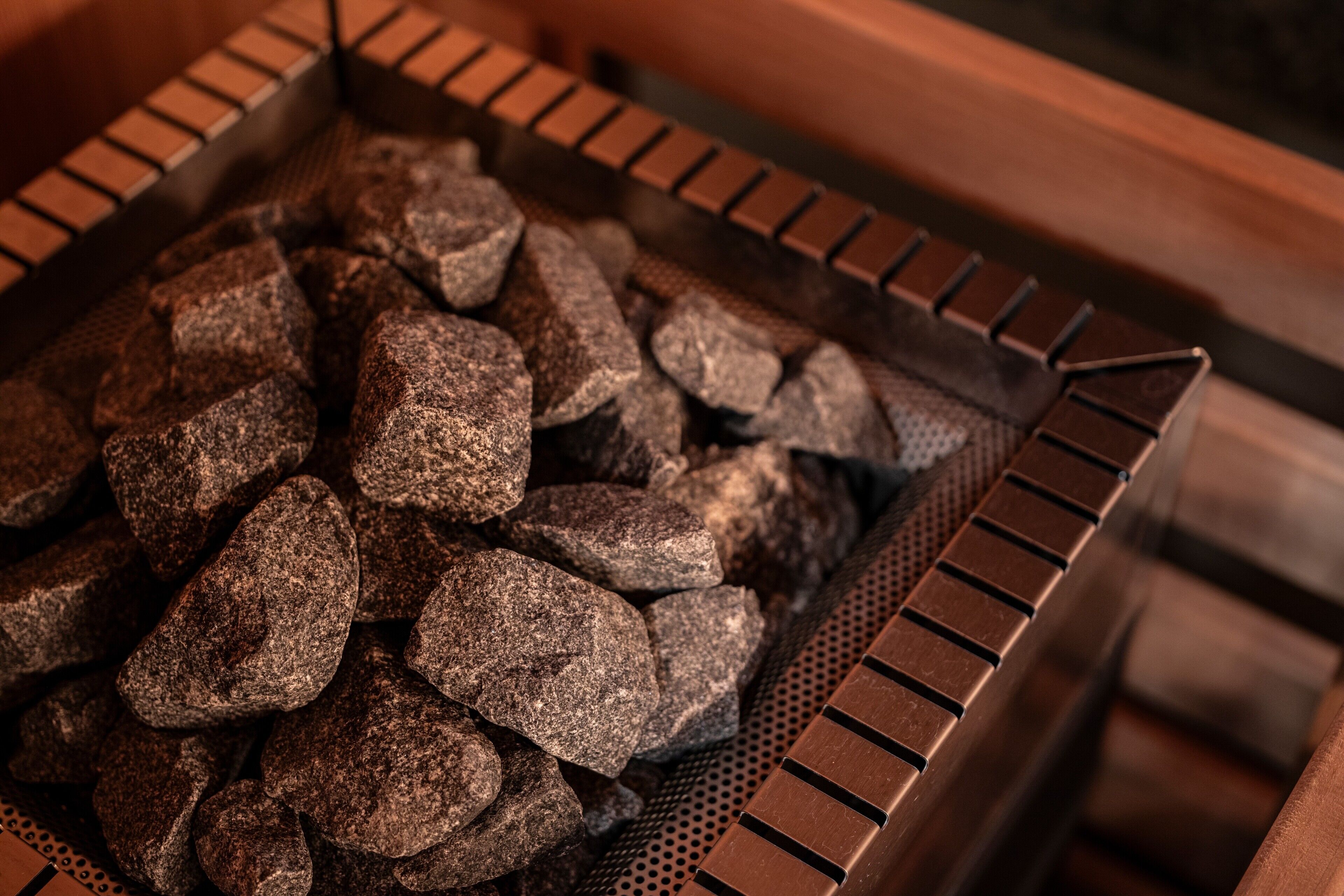 A close-up of a metal grate filled with charcoal briquettes.