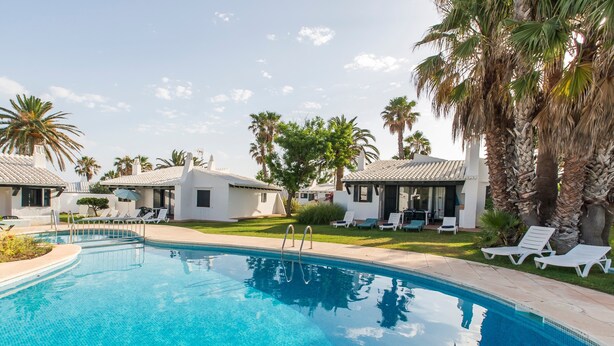 A swimming pool with lounge chairs and palm trees. - Beautiful Holiday Home in Residential Complex with Pool, Wi-Fi, Terrace and Lawn (Binisafua)