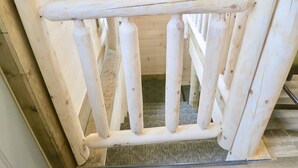 A wooden interior with a simple, rustic design. - Rocky Pine Cabin. Hot Tub, and Pet Friendly! (Nelsonville)