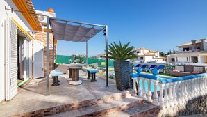 A patio area with a pool, outdoor furniture, and a staircase leading to a building. - Mediterranean Villa "Calipso" with Wi-Fi, Terrace and Pool (Albufeira)