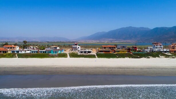 A coastal area with beach houses and a mountain backdrop. - La Haciendita Beachfront Home + Private Pool (Ensenada)
