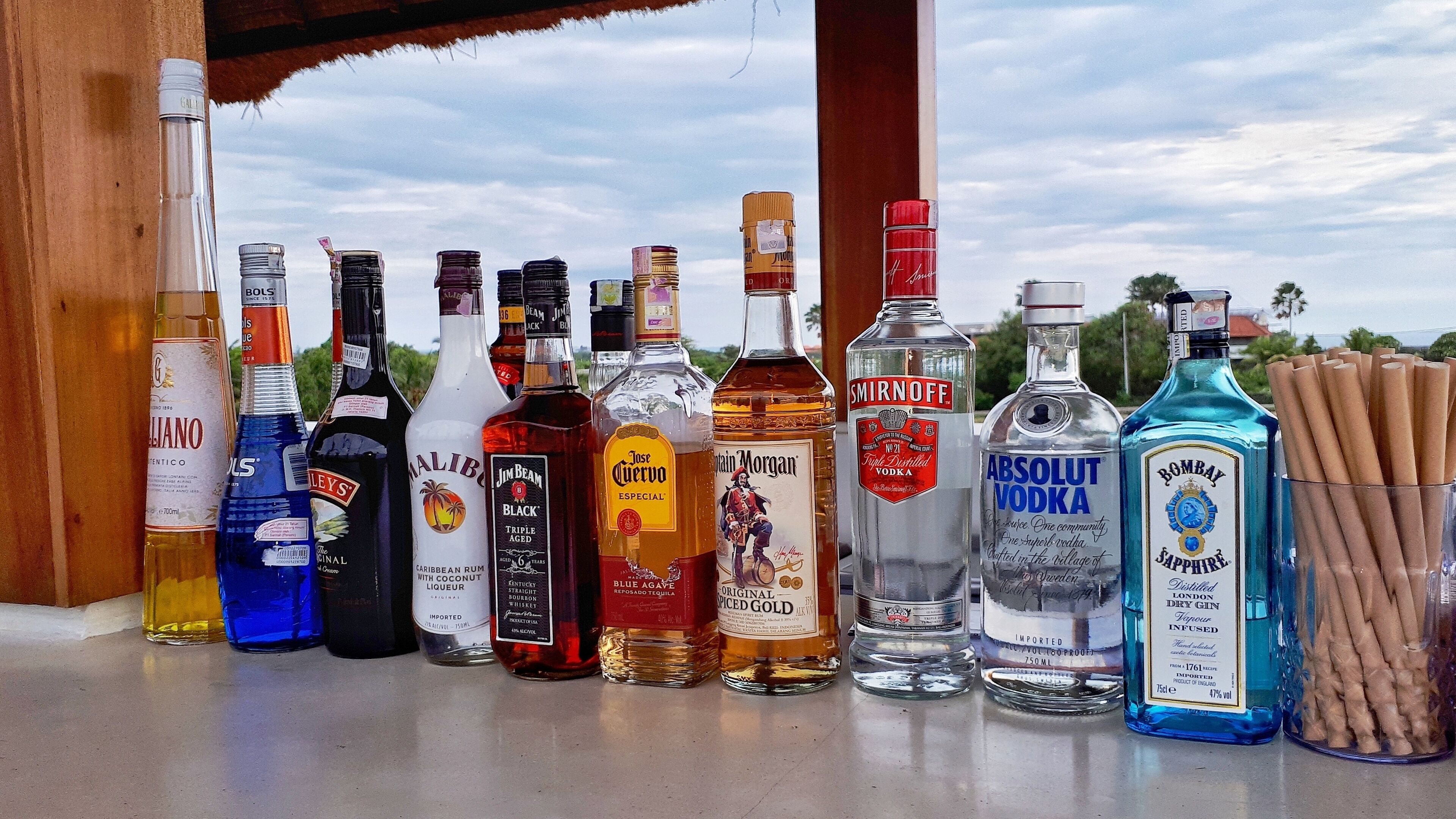A variety of alcohol bottles displayed on a counter.