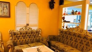 A room with ornate, patterned sofas and a large, ornate coffee table. - Dot King Villa (Taipei)
