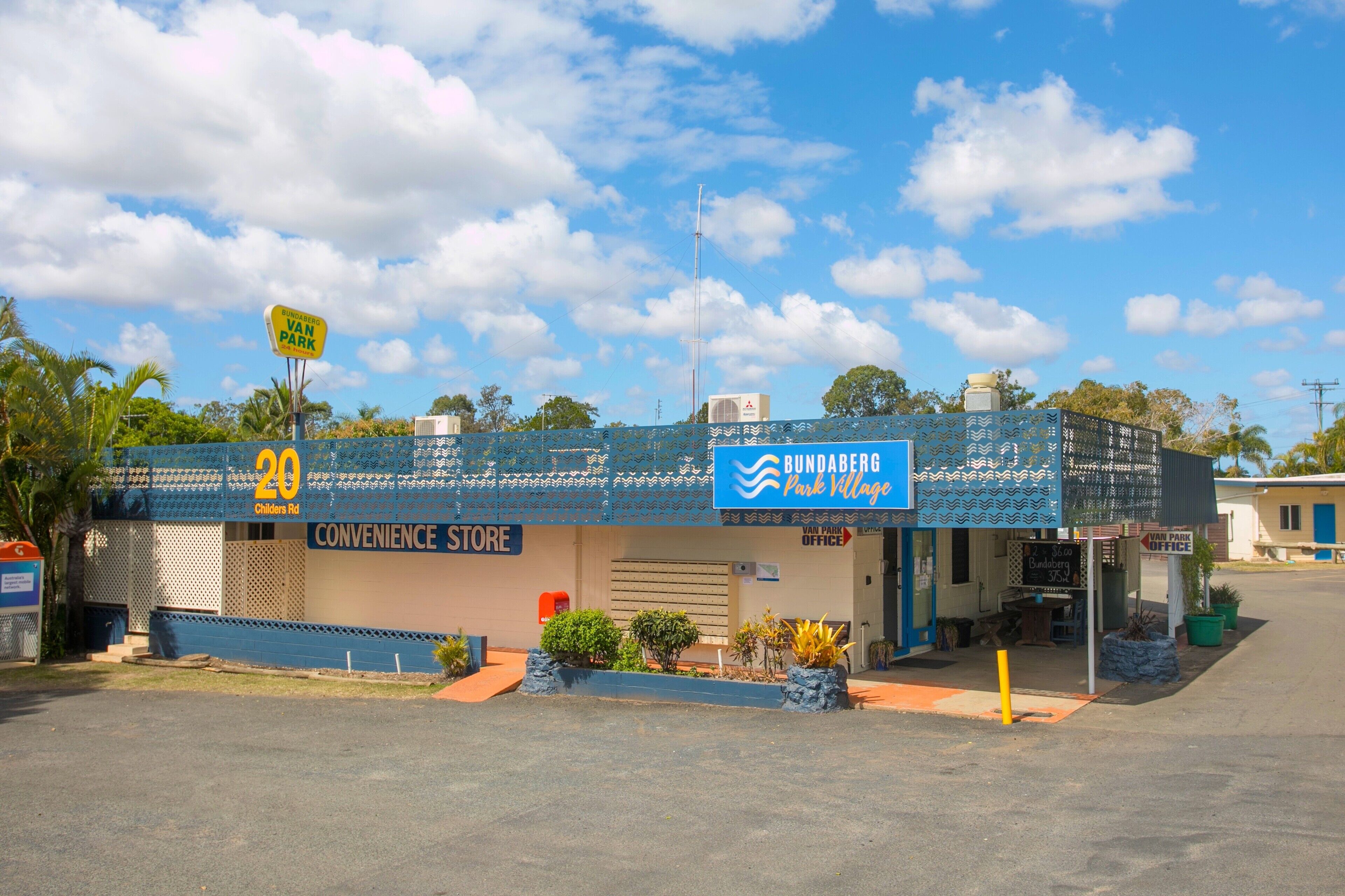 A building with a sign for 'BUNDABERG Park Village' and a 'CONVENIENCE STORE' on the ground floor.