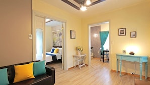 A living room with a sofa, a small table, and a bed in the background. - Gyeongju Europe Village Pension (Gyeongju)