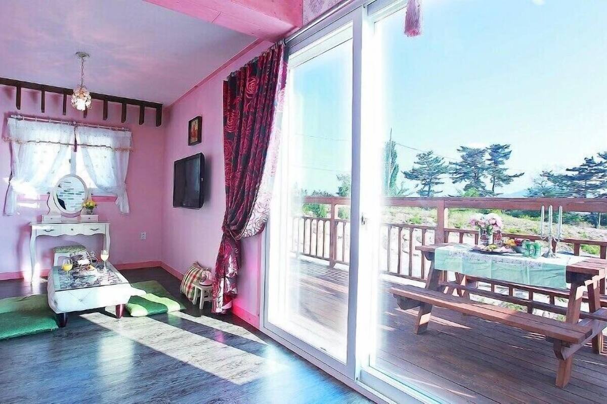 A room with a large sliding glass door leading to an outdoor deck.