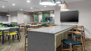 A modern restaurant with a central island, multiple seating areas, and pendant lighting. - Fairfield Inn & Suites by Marriott Rocky Mount (Rocky Mount)
