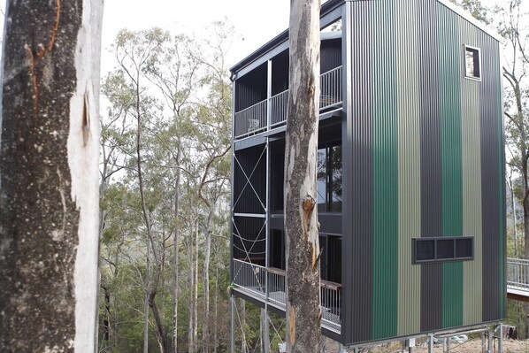 A multi-story building with balconies, surrounded by trees. - Treehouse #3, 3 Levels, Large BBQ. Amazing views (Austinville)
