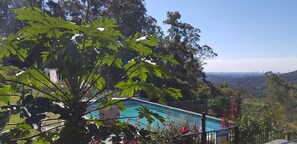 A pool with a clear view of the city skyline in the background. - Treehouse #3, 3 Levels, Large BBQ. Amazing views (Austinville)