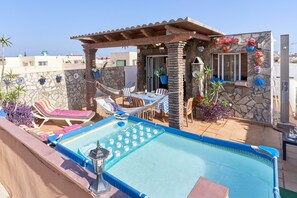 A rooftop pool area with lounge chairs, a table, and a pergola. - Air-Conditioned Apartment Close to Beaches with Rooftop Terrace (Nerja)
