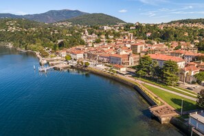 A riverside town with historic buildings, a bridge, and a marina.