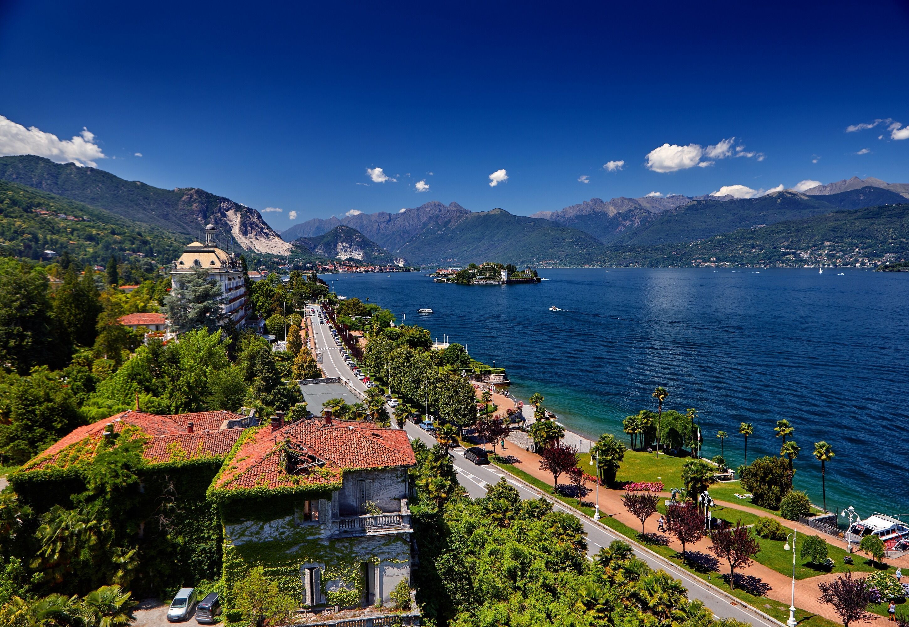 A coastal town with a prominent church, a marina, and a mountain backdrop.