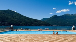 A pool area with a view of mountains and a clear sky.