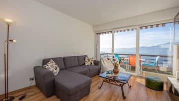 Family Apartment, 2 Bedrooms, 2 Bathrooms, Mountainside (Aldesago Panoramica) | Living area | 22-inch flat-screen TV with digital channels, TV, stereo