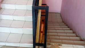A staircase with white tiles and a black metal railing. - Jackmart Lodge - Adults Only (Nakuru)