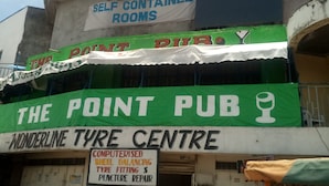 A building with signage for 'The Point Pub' and 'Wonderline Tyre Centre'. - Jackmart Lodge - Adults Only (Nakuru)