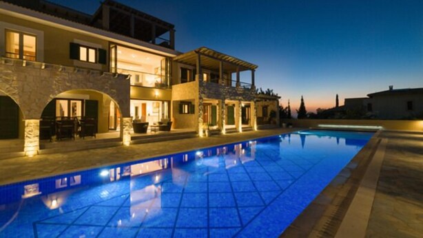 A modern villa with a swimming pool, stone arches, and a covered outdoor area. - Villa 141 - Rio (Kouklia)