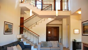A spacious living area with a staircase, two sofas, a fireplace, and a framed picture on the wall. - Villa 32 - Limni (Kouklia)