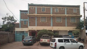 A two-story building with a sign reading "Kittie Lodge."