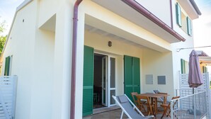 A house with a covered patio, a dining area, and a staircase leading to the entrance. - Holiday Home 'Il Timo' with Sea View, Wi-Fi and Air Conditioning (Marciana)