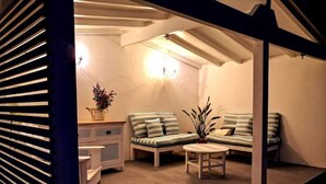 A cozy room with a sofa set, a small table, and a cabinet.