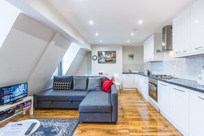 Apartamento superluxo | Área de estar | TV de tela plana 28 polegadas com canais digitais, TV, Netflix