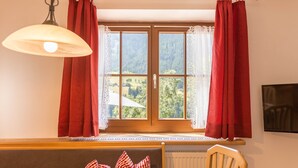 A room with a window, a table, a chair, and a radiator. - Holiday Apartment "Christa B1" with Wi-Fi near Various Ski Resorts (Ortisei)