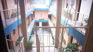 A multi-level residential building with balconies, staircases, and potted plants. - Mocharo Hotel (Isiolo)