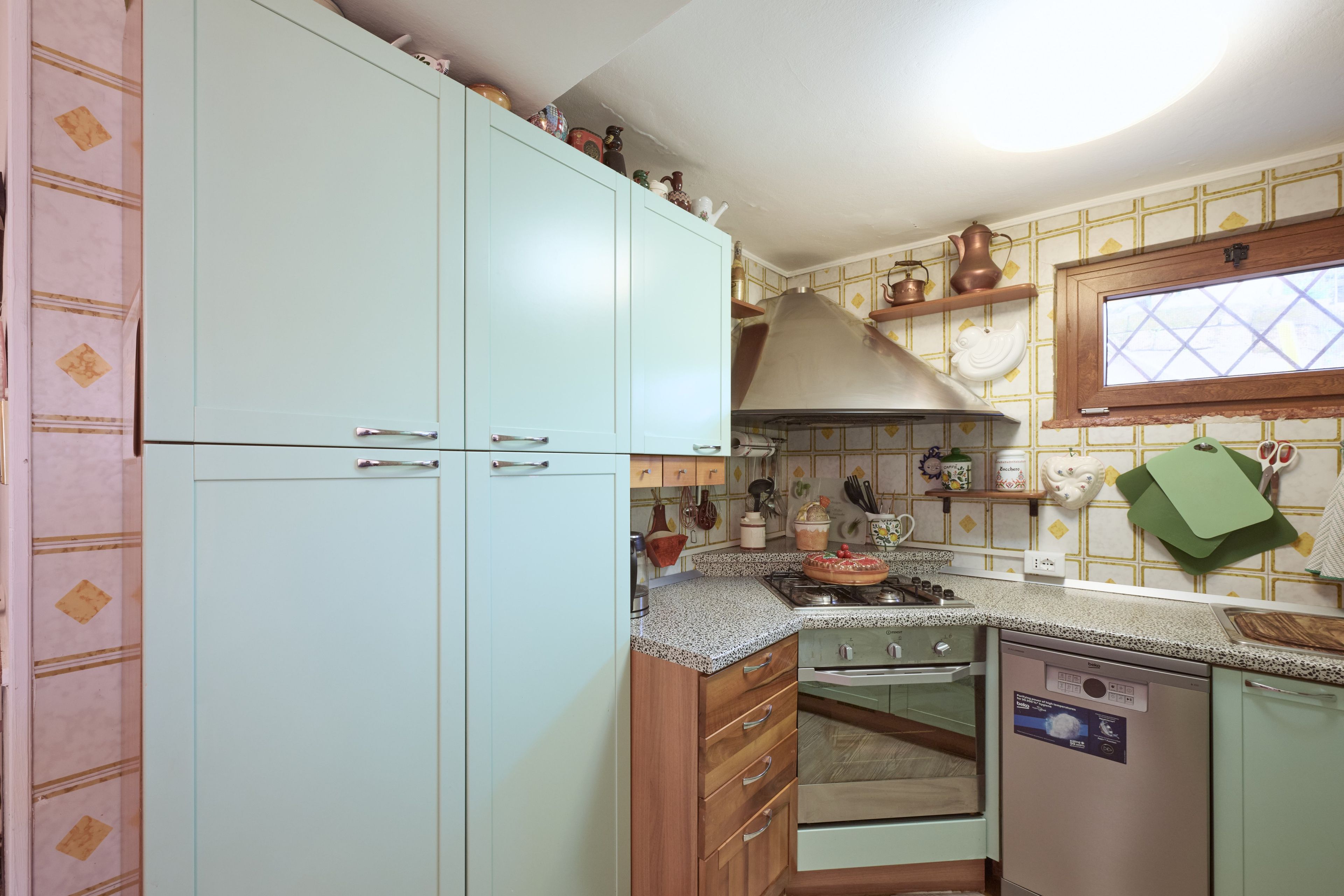 A kitchen with a stove, oven, and cabinets.