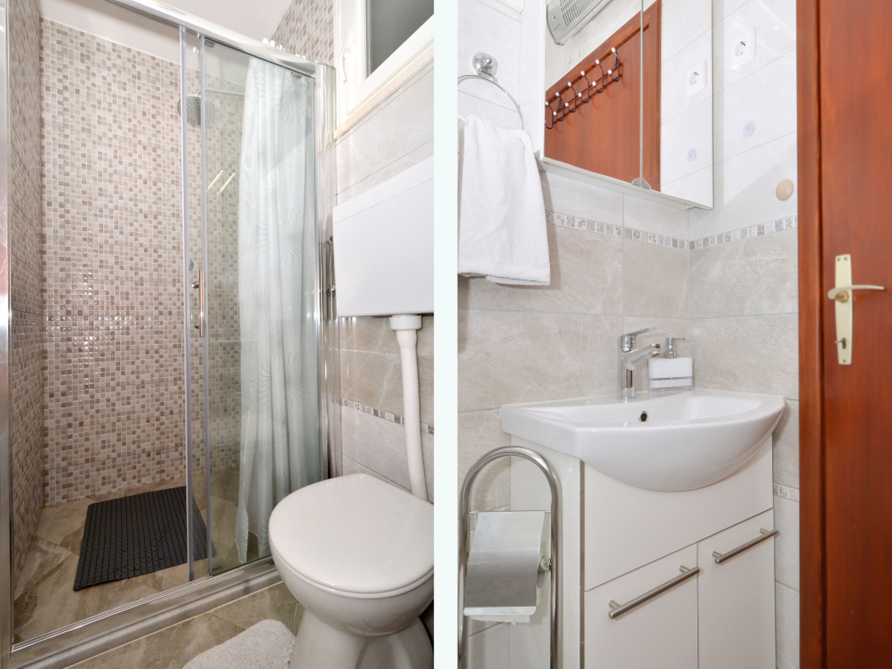 A bathroom with a glass shower enclosure, a toilet, and a sink with a mirror.