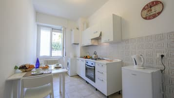 Family Apartment, 2 Bedrooms (Casa Al Caprifoglio 600m From Beach) | Private kitchen | Fridge, microwave, oven, stovetop