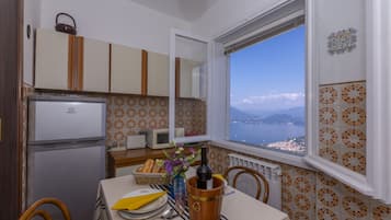 Family Apartment, Multiple Bedrooms, Mountainside (Nicoletta's Lake View Stresa) | Private kitchen | Full-size fridge, microwave, oven, stovetop