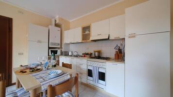 Family Apartment, 1 Bedroom (Petalo Bianco 100m from lake) | Private kitchen | Full-size fridge, microwave, oven, stovetop