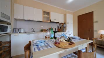 Family Apartment, 1 Bedroom (Petalo Bianco 100m from lake) | Private kitchen | Full-size fridge, microwave, oven, stovetop