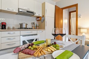 Family Apartment, Multiple Bedrooms (Petalo Bianco 100m from lake) | Private kitchen | Full-size fridge, microwave, oven, stovetop