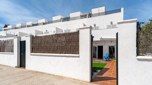 A modern white building with a flat roof, a covered patio area, and a small garden. - Family-Friendly Home Casa Noah Close to Beach with Pool, Terrace, Balcony & Wi-Fi (CONIL de la Frontera)