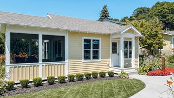 A single-story house with a covered porch, a front door, and a small attached garage.