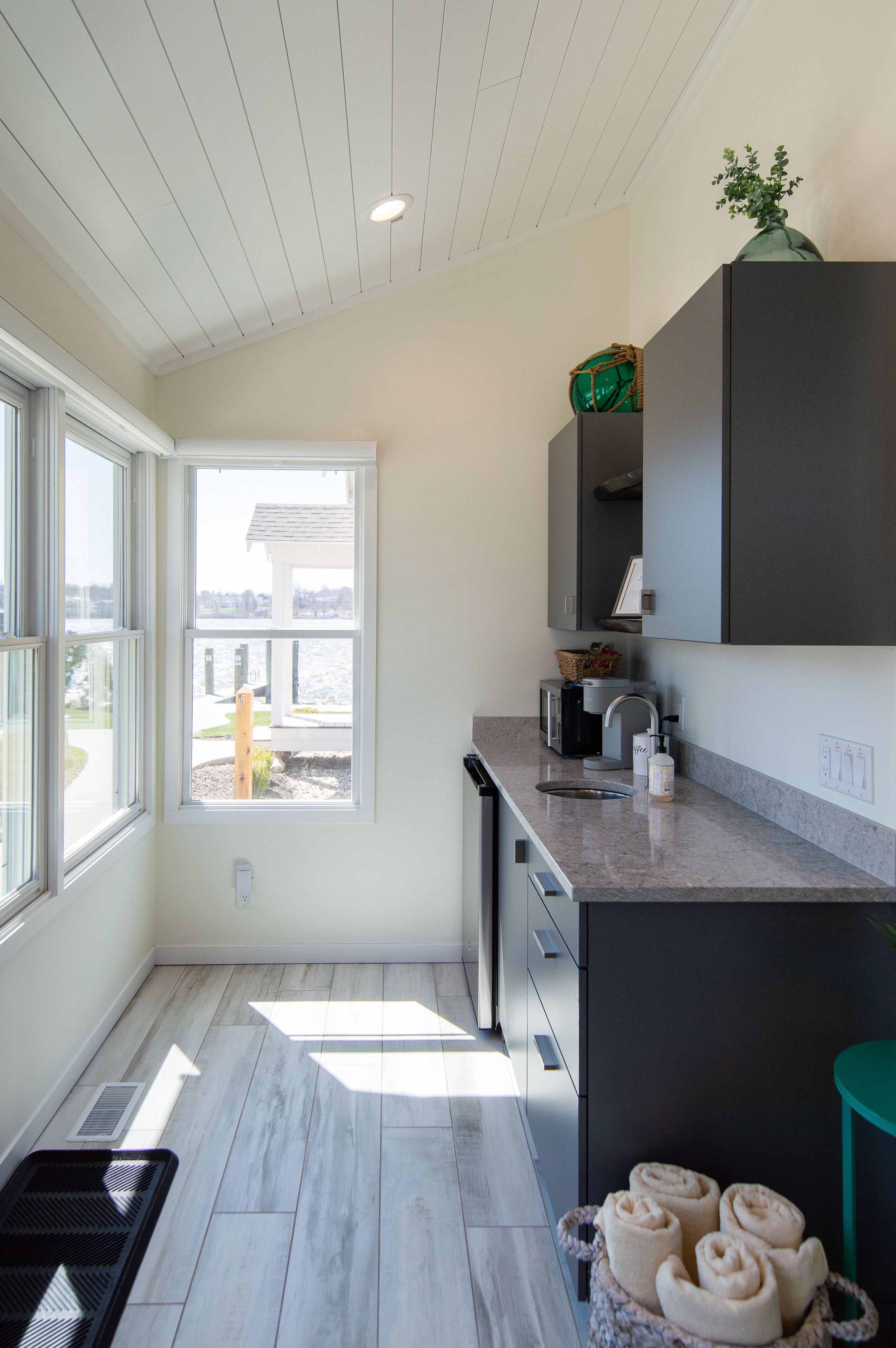 A modern kitchen with a large window, a built-in oven, and a sink.