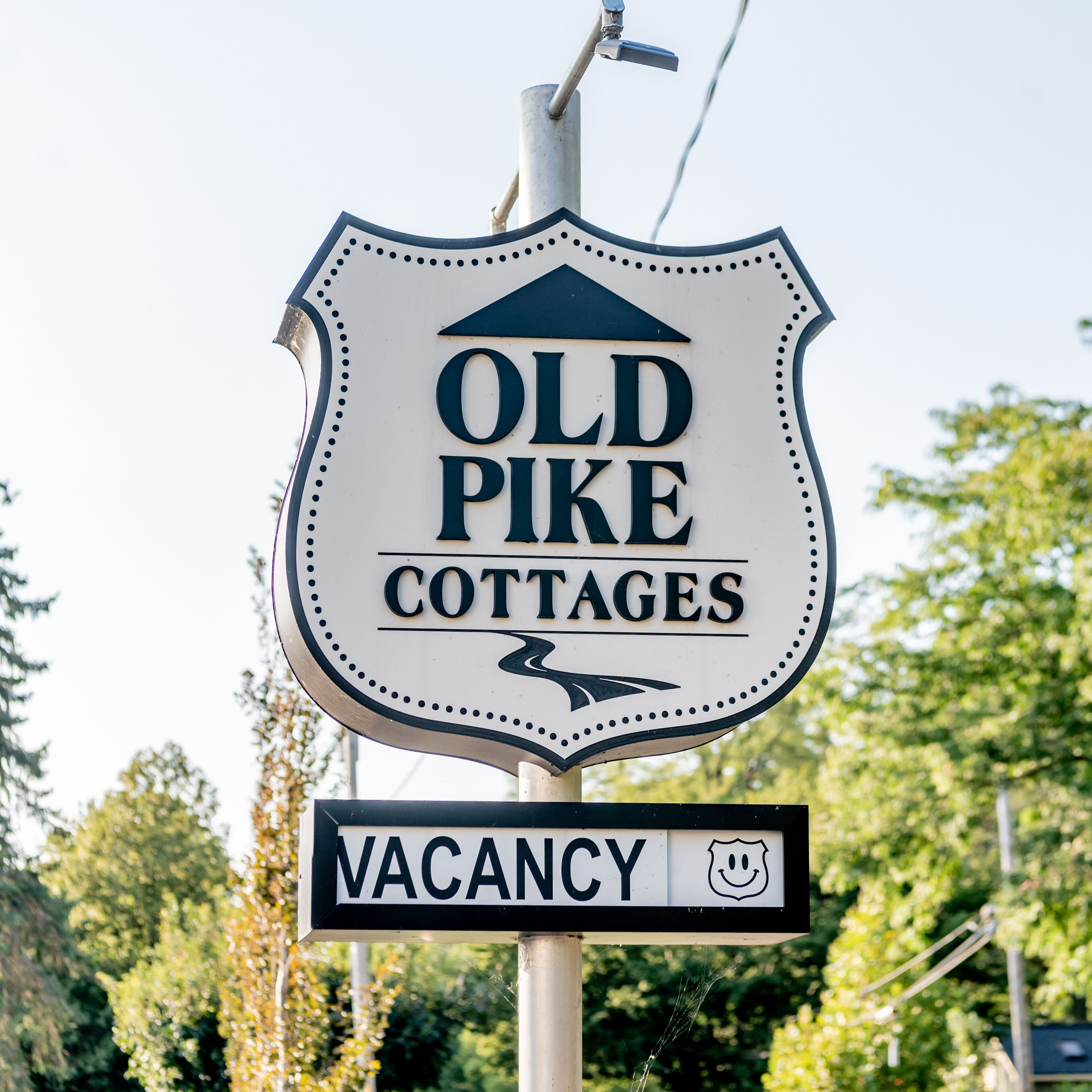 A sign for Old Pike Cottages indicating a vacancy.