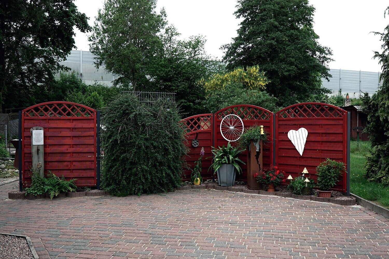 A gated entrance with a brick pathway leading to a building.