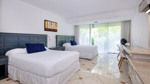 A hotel room with two beds, a desk, and a chair.