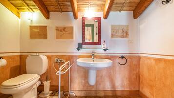 A bathroom with a toilet, sink, and shower.