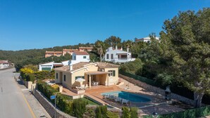 A residential property with a swimming pool, a patio with outdoor furniture, and a view of the surrounding neighborhood. - Vacation Home "Villa Llebeig" Near the Beach with Sea View and Pool (San Jaime Mediterráneo)