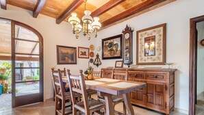 A dining area with a wooden table and chairs, a wooden cabinet, and a chandelier. - Villa "Can Sol" with Private Pool and Large Garden in Pollensa (Pollensa)