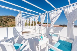 A white wicker lounge area with a view of a hilly landscape. - Andalusian Home with Pool, Rooftop Terrace "Love under the Stars" & Mountain View (Sayalonga)