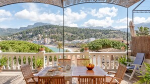 A terrace with a table set for breakfast, chairs, and potted plants. - Villa on the Beach with Sea View in Port de Soller. Garden and Wi-Fi (Sóller)