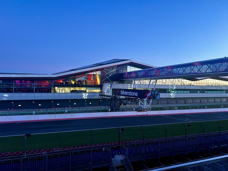 A stadium with multiple levels, a large advertising board, and a track field.